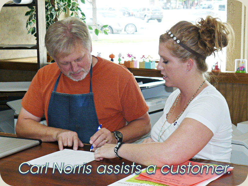 Carl Norris assists a customer.
